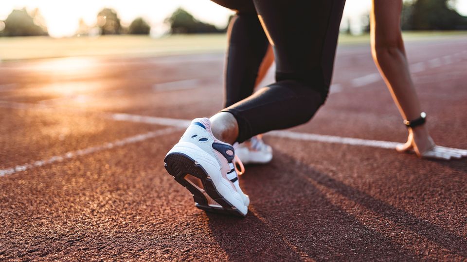 A female runner at the starting line of a race.