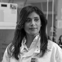 A headshot of Dr. Madusha Peiris in greyscale.