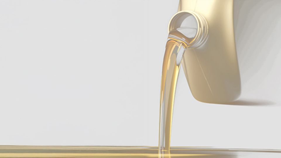 Golden biofuel being poured from a container, illustrating biodiesel purity and trace element analysis.